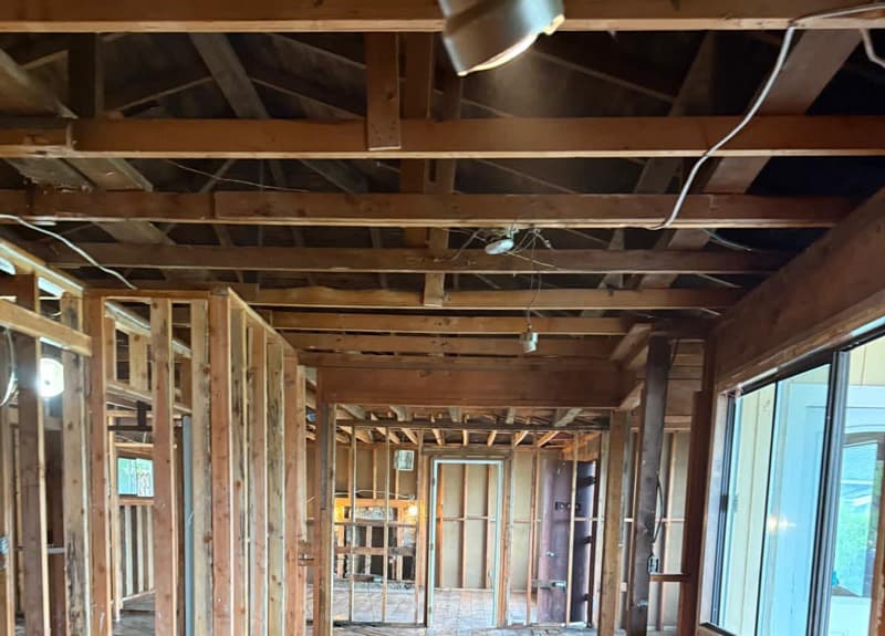 A house interior stripped to its studs during demolition work