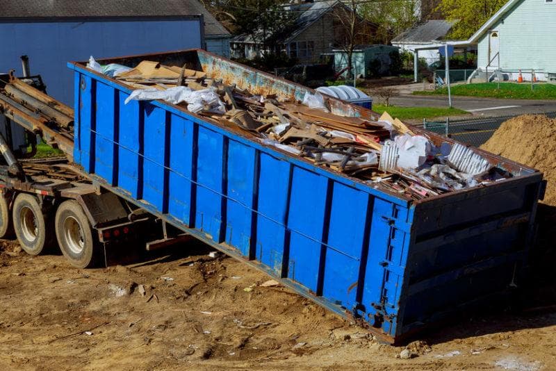 A debris bin loaded with construction waste