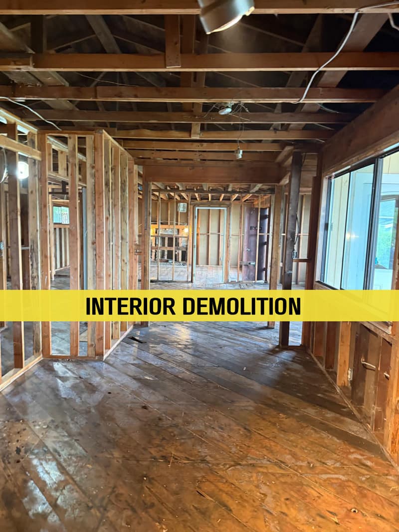 A house interior stripped to its studs during demolition work